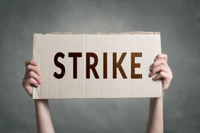 Hands,Holding,Protest,Signs.,Workers,Going,On,Strike.