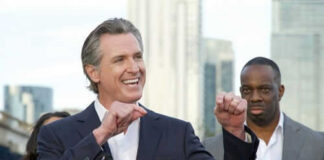 Man speaking passionately at outdoor event with audience