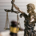 Bronze statue of Lady Justice holding scales.