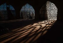 Axe-Wielding Intruder Breaches Mosque Interior view showcasing intricate geometric patterns and shadows cast by windows