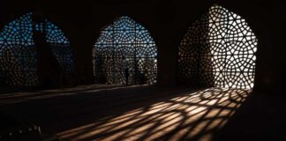 Interior view showcasing intricate geometric patterns and shadows cast by windows
