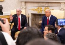 Tehran in Chaos: US-Israel Strike Unleashed! Two political leaders engaged in discussion in a formal setting