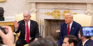 Two political leaders engaged in discussion in a formal setting