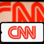 CNN logo on phone and screen background.