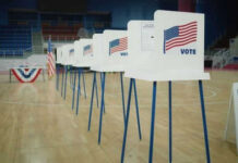ICE Agents at Polls? DOJ’s Shocking Proposal Voting booths lined up in a gymnasium.