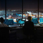Air traffic controllers working at night airport tower