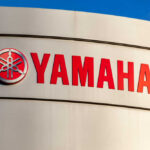 Yamaha logo displayed on a sign against a blue sky