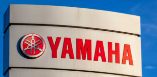 Yamaha logo displayed on a sign against a blue sky