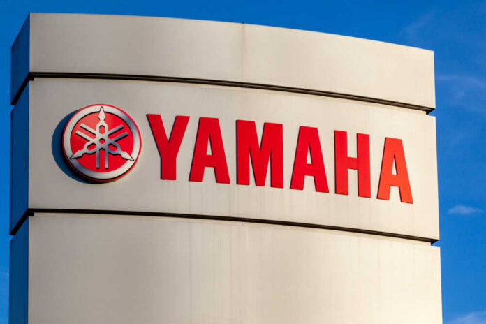 Yamaha logo displayed on a sign against a blue sky
