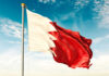 Flag of Bahrain waving against a blue sky