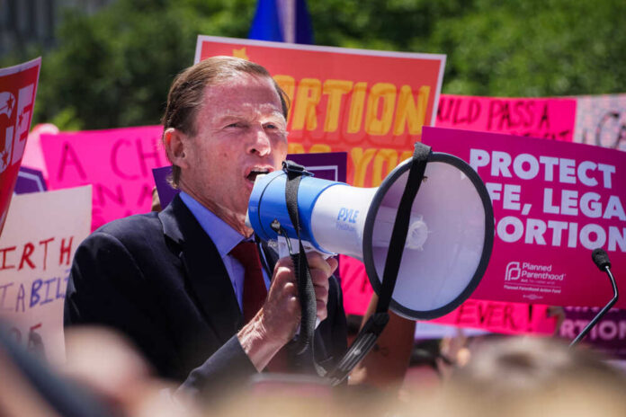 A speaker using a megaphone at an abortion rights protest