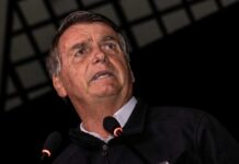 A man speaking into a microphone during a public event