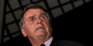 A man speaking into a microphone during a public event