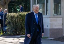 A man in a formal suit walking outdoors