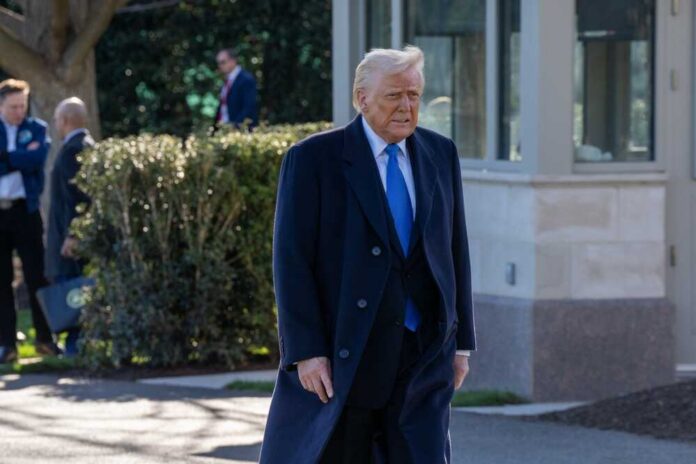 A man in a formal suit walking outdoors