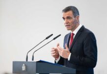 A government official delivering a speech at a podium