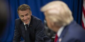 Two political leaders engaged in a conversation, one smiling