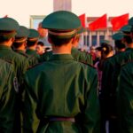 Group of uniformed soldiers standing in formation during a ceremony