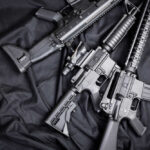 Black rifles on a dark fabric background