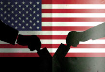 Silhouetted handshake over United States flag background