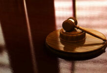Gavel on a wooden table in sunlight