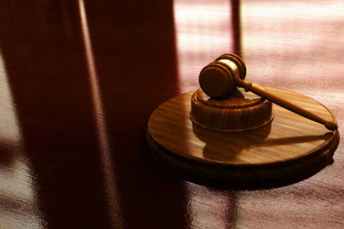 Gavel on a wooden table in sunlight