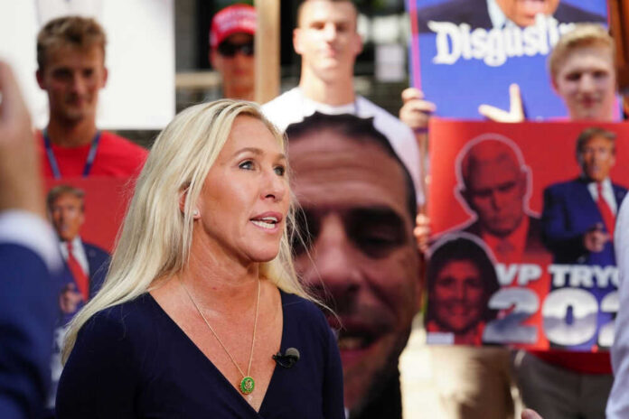 Woman speaking with people holding political signs background