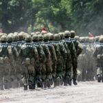 Japan’s Militarism Revival Shocks Beijing Soldiers in camouflage uniforms marching in formation during a military parade
