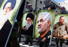 Fraudulent Asylum Claim EXPOSED – Soleimani Family Under Fire Demonstrators holding large portraits of military and political figures during a protest