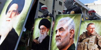 Demonstrators holding large portraits of military and political figures during a protest