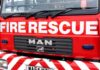 Close-up of a red fire rescue truck with bold lettering