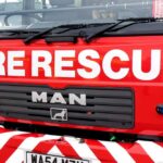Close-up of a red fire rescue truck with bold lettering