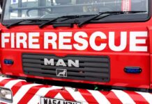 Close-up of a red fire rescue truck with bold lettering