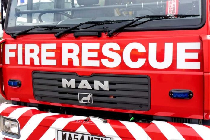 Close-up of a red fire rescue truck with bold lettering