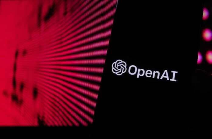 shutterstock_2253487389.jpg Close-up of a smartphone displaying the OpenAI logo against a vibrant digital background