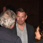 Explosive Allegations: Swalwell’s Campaign in Crisis Group of people engaged in conversation at a social event