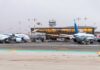 Airplanes parked at Ben Gurion Airport with terminal in the background