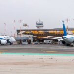 Airplanes parked at Ben Gurion Airport with terminal in the background