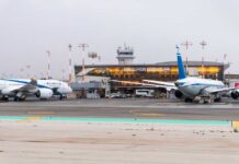 Airplanes parked at Ben Gurion Airport with terminal in the background