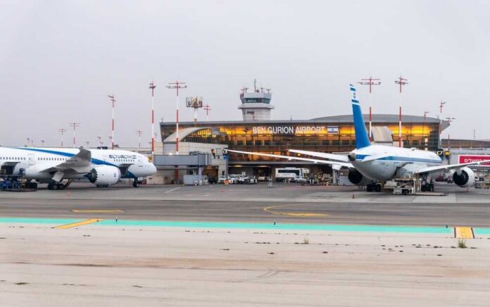 shutterstock_2493097679.jpg Airplanes parked at Ben Gurion Airport with terminal in the background