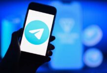 Telegram’s Disturbing Secret: Massive Image Trade A smartphone displaying the Telegram logo against a blue background