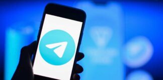 A smartphone displaying the Telegram logo against a blue background