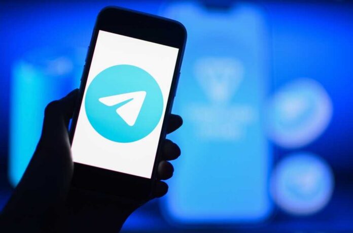 A smartphone displaying the Telegram logo against a blue background