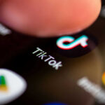 TikTok Post Prompts Military Mom’s Emotional Outcry Finger tapping TikTok app on a smartphone screen