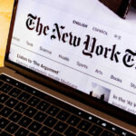 Laptop screen displaying New York Times website.