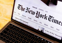 Laptop screen displaying New York Times website.