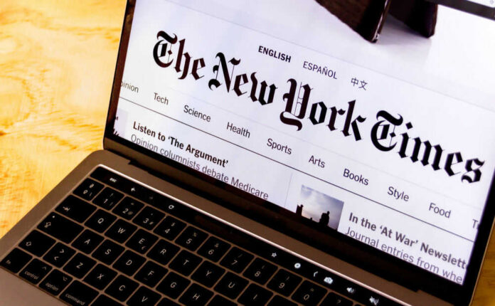 Laptop screen displaying New York Times website.