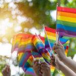Colorado’s Stealth Move CRUSHES Parental Rights Hands waving rainbow pride flags outdoors