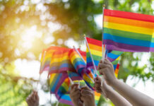 Colorado’s Stealth Move CRUSHES Parental Rights Hands waving rainbow pride flags outdoors