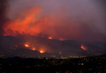 Google Maps ERASING History with Pre-Fire Images Wildfire glows on hills above a city at dusk